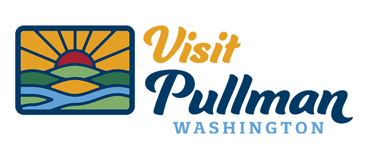 Visit Pullman Washington logo showing a sun rising over hills